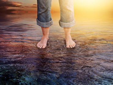 Two feet are firmly standing on water